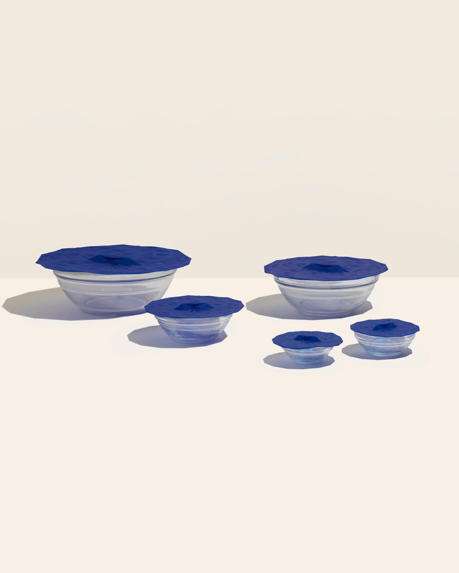 GIR Round Navy Suction Lids covering bowls on a Cream Background. 