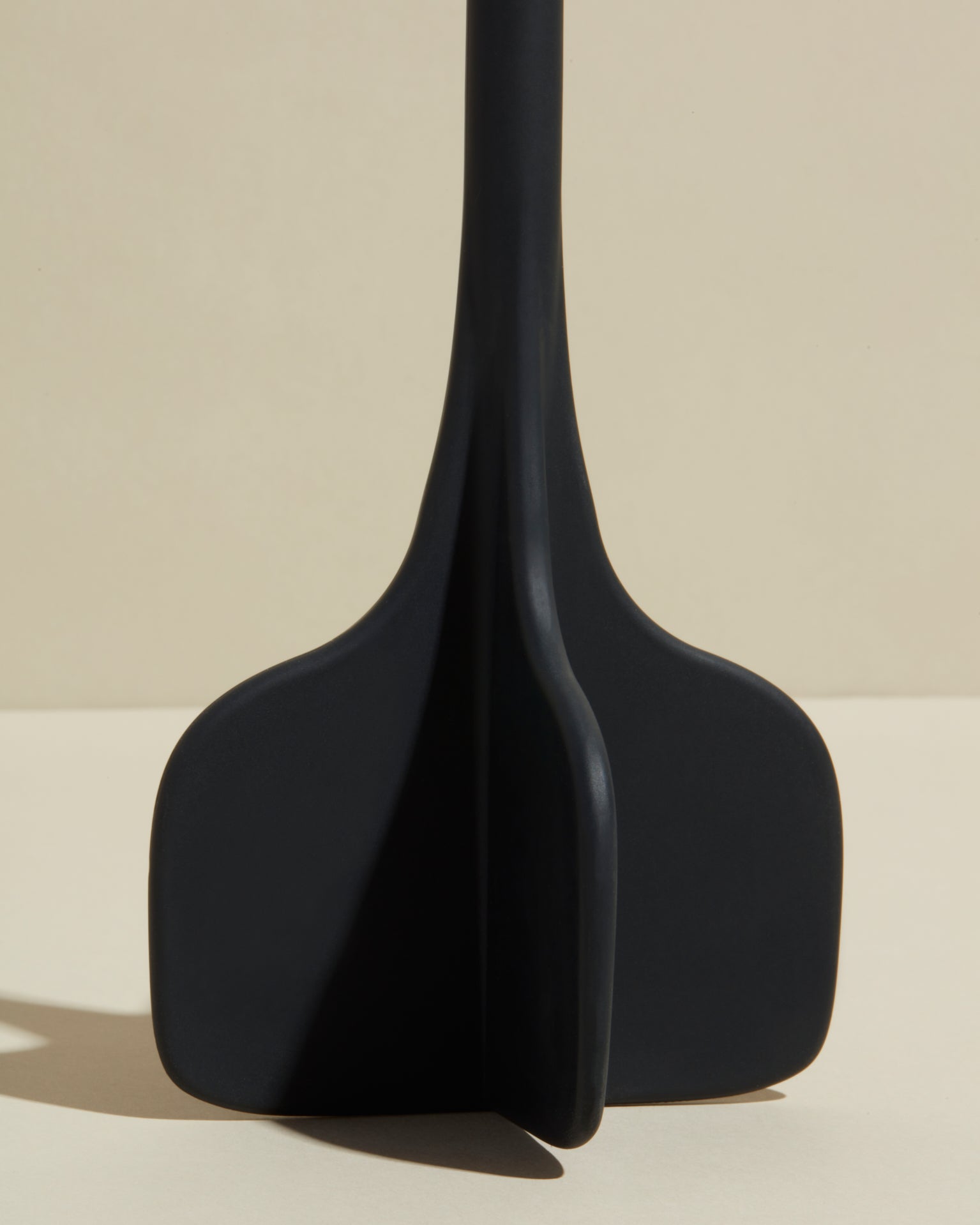 Close-up image of the GIR Black Quad Chopper on a cream background.