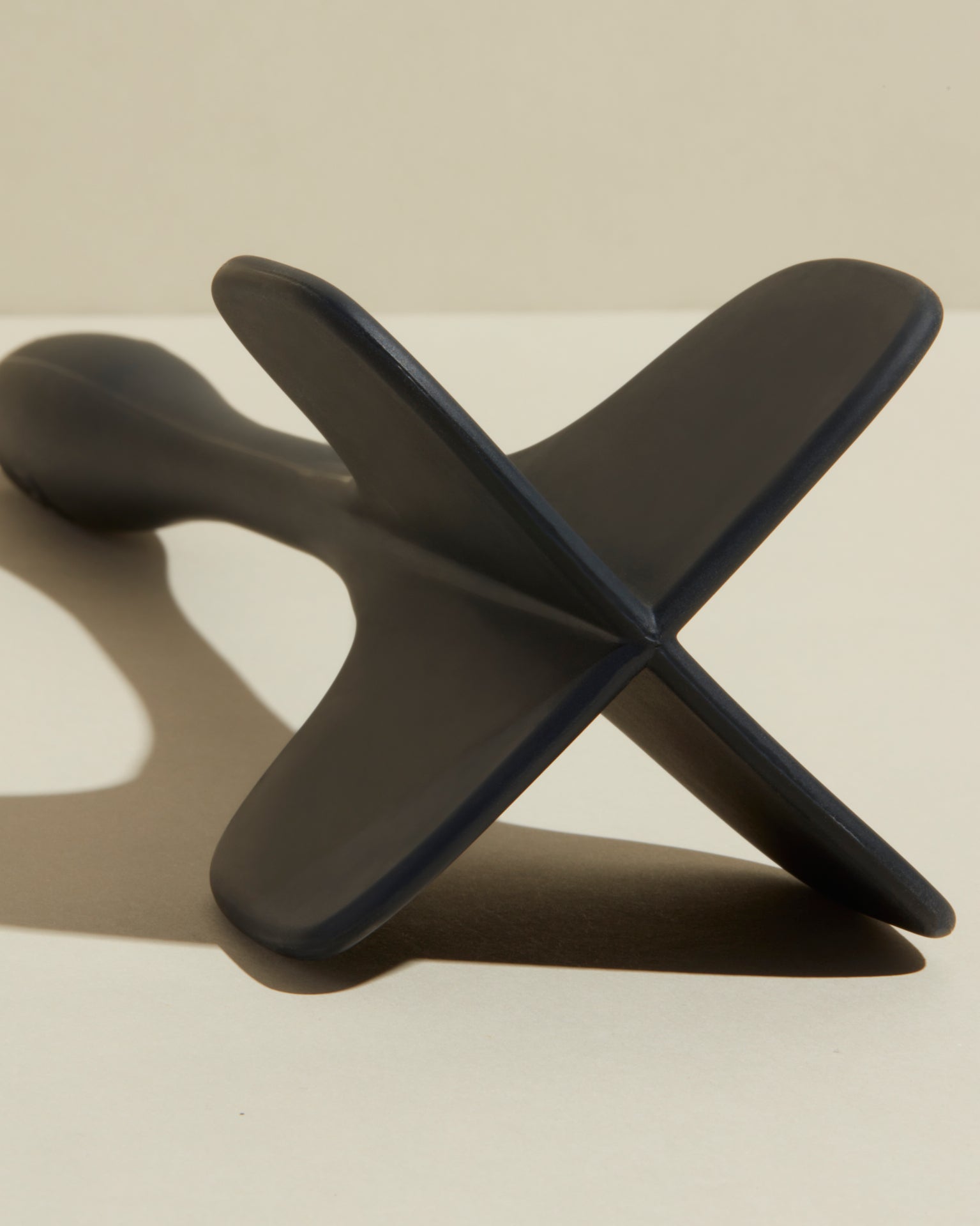 Close-up image of the GIR Black Quad Chopper on a cream background.