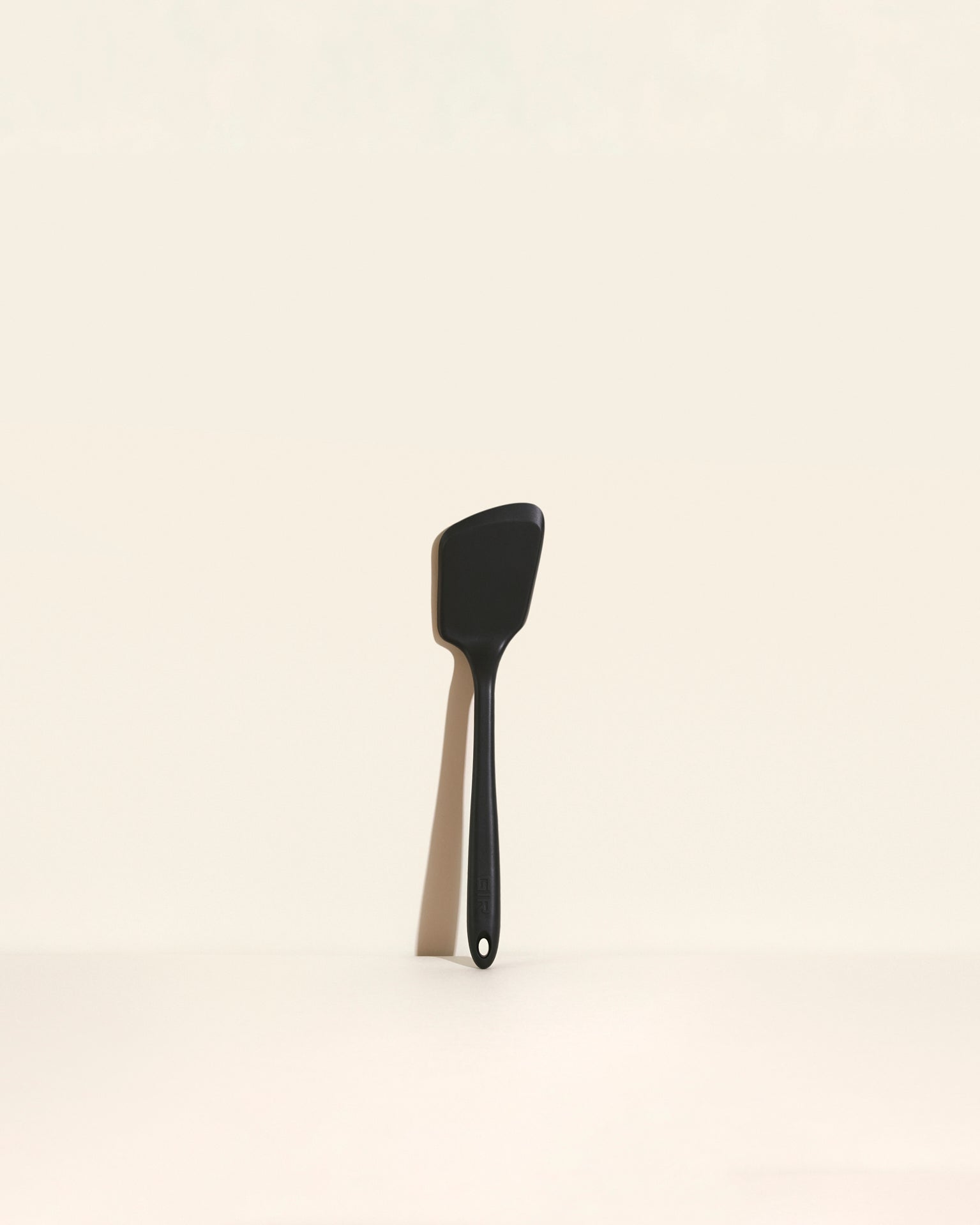 The Black Mini Flip on a cream background. 