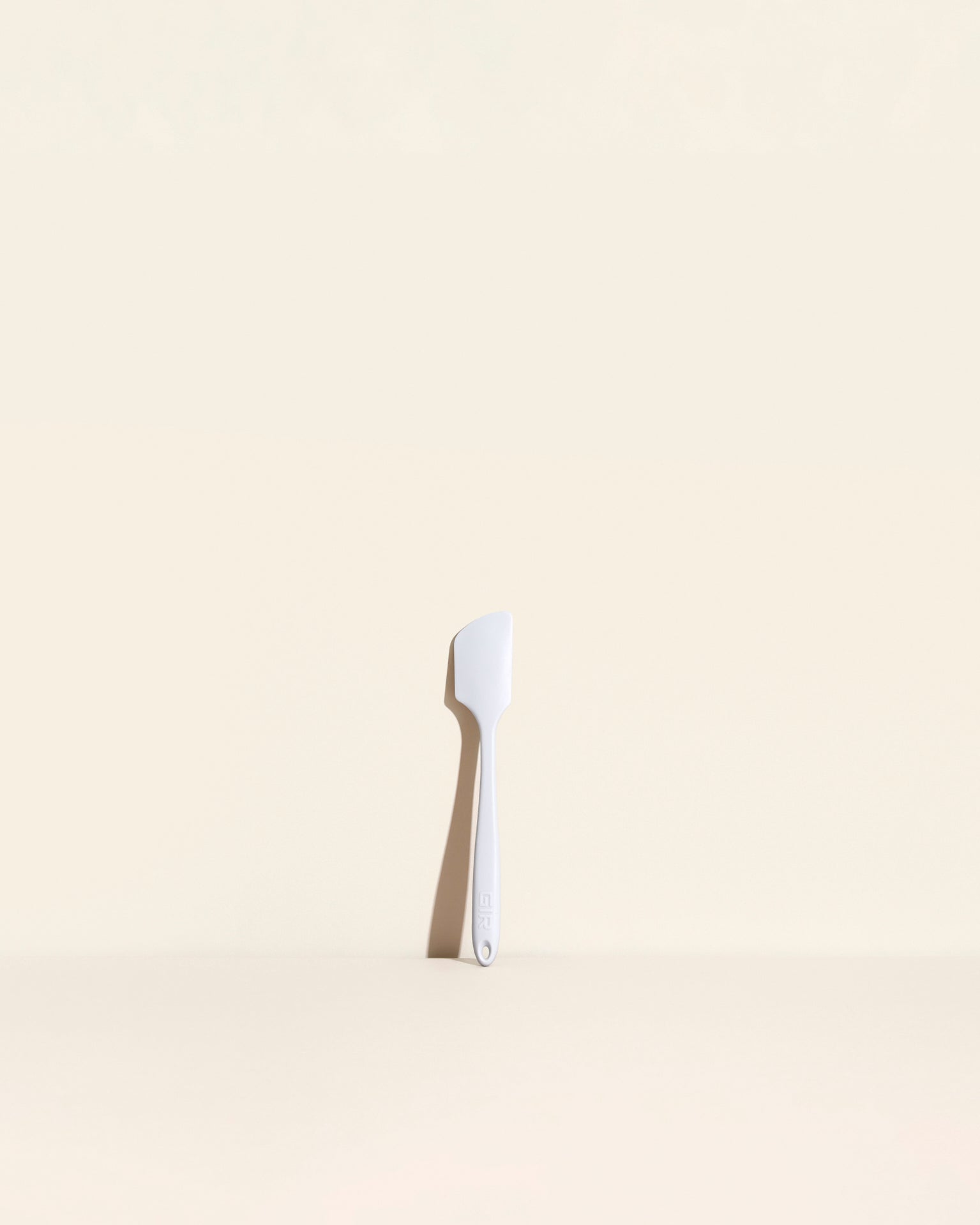 The Studio Mini Spatula on a cream background. 