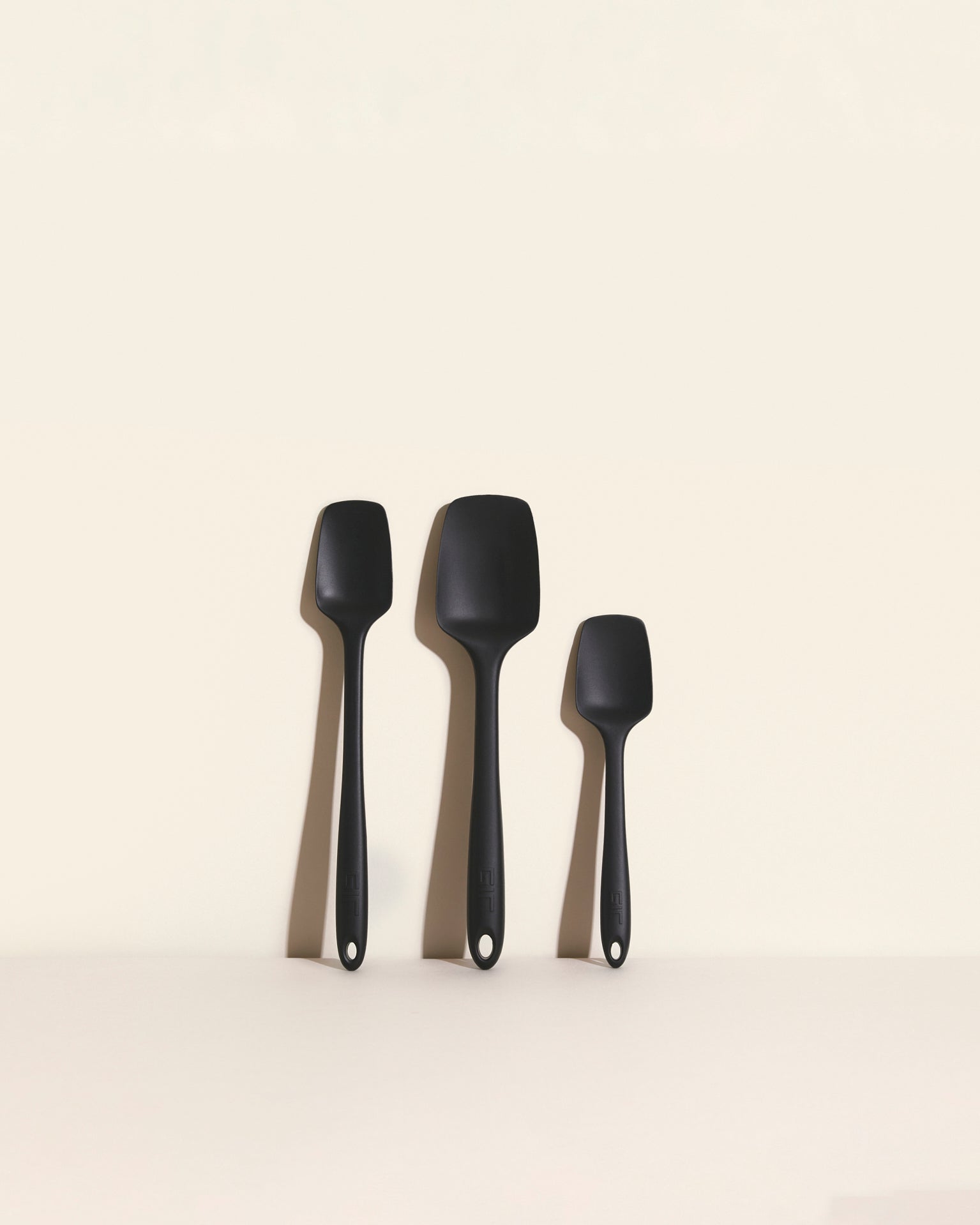 3-Piece Spoonula Set featuring three black spatula utensils in different sizes against a neutral background.