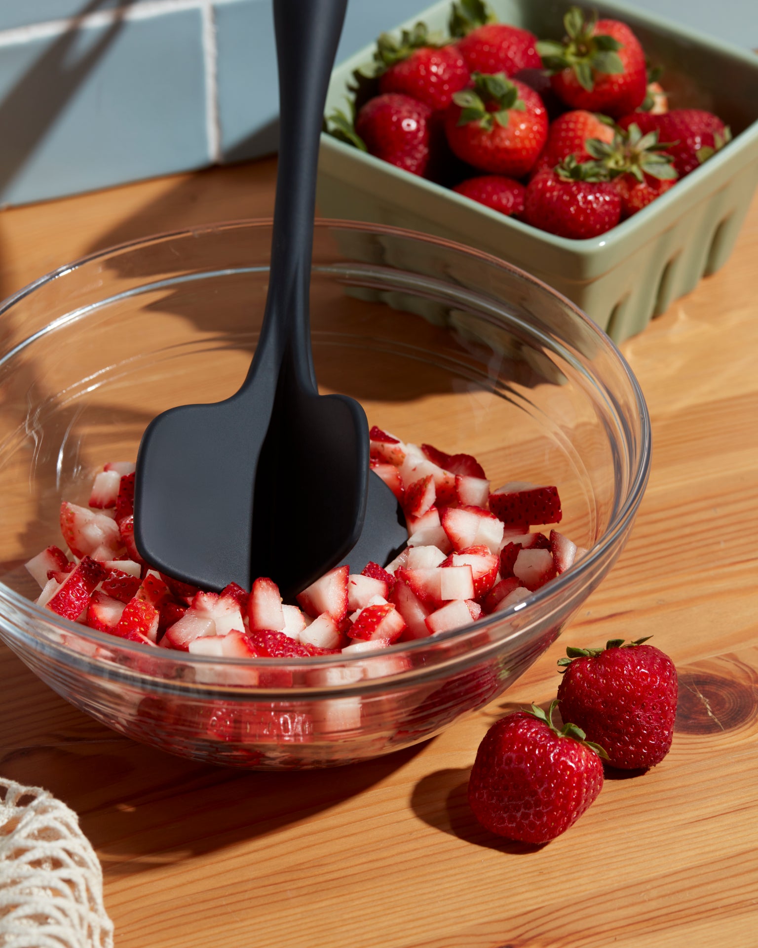 GIR Quad Chopper In Black used to chop strawberries.